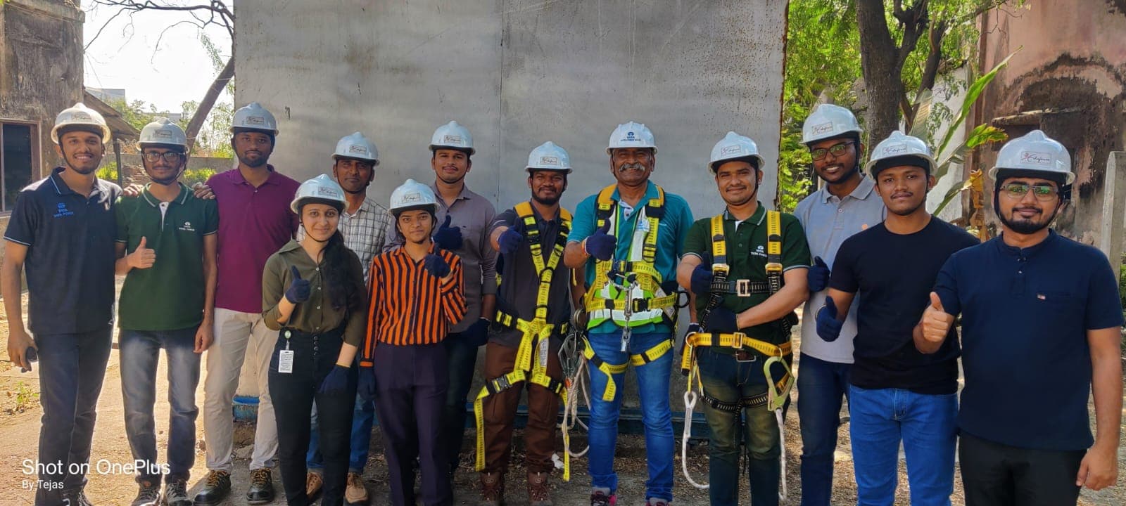 Trainees in helmets and harnesses lined up with their fall-protection equipment during a working-at-height session