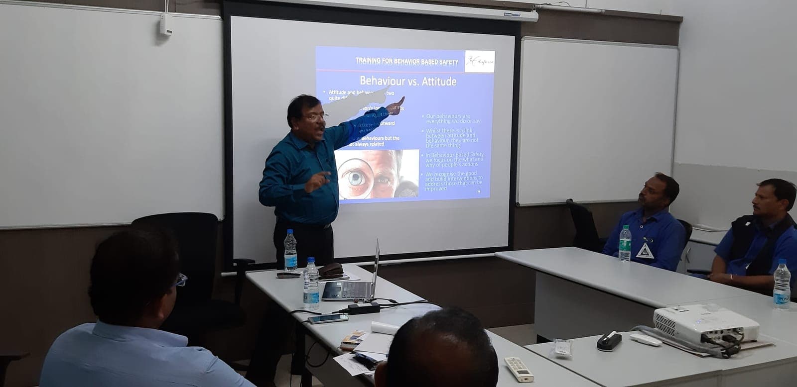 Trainer and participants in an Eduforce classroom reviewing safety documentation