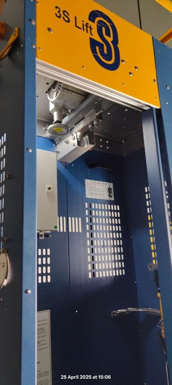 Blue 3S Lift service lift cabin with its door open inside a wind turbine tower