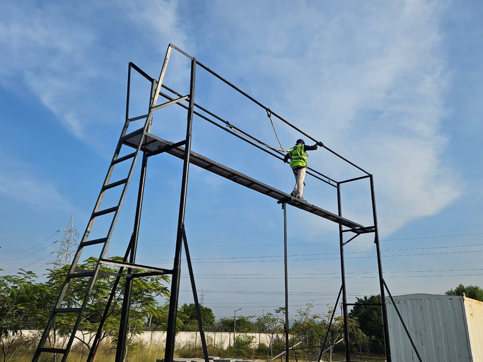 Trainee moving along a lifeline training gantry, connected to the horizontal lifeline overhead