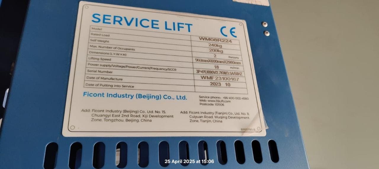 Rating plate on a blue service lift showing its model, rated load, lifting speed and CE mark