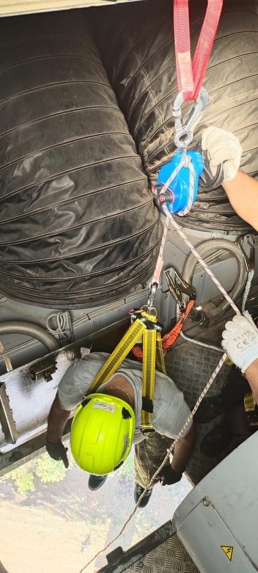 Rescue descent being carried out inside a wind turbine hub with rope equipment rigged overhead