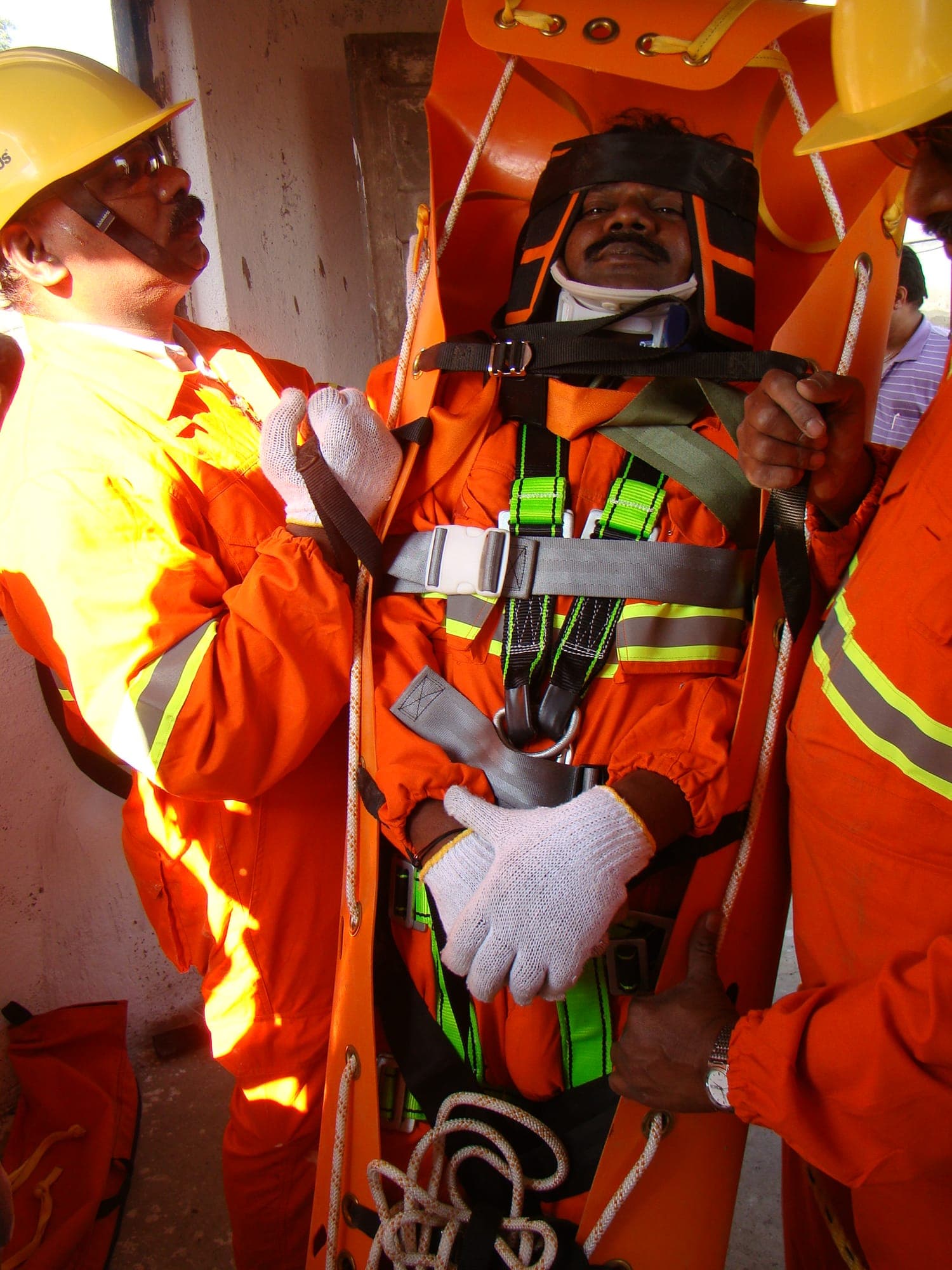 Casualty secured in a stretcher being raised vertically through a confined space opening