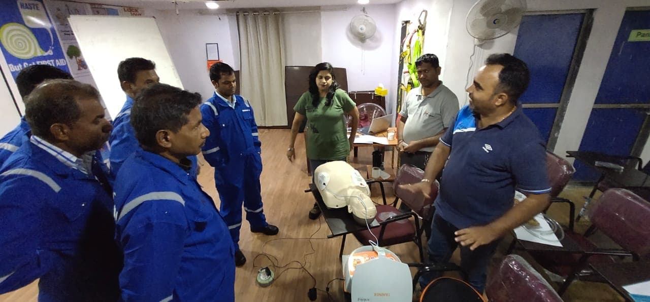 Instructor showing resuscitation training equipment to participants during a first aid session