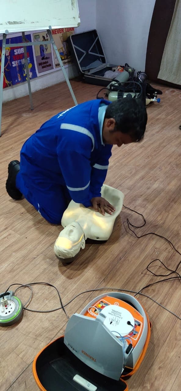 Participants taking turns practising cardiopulmonary resuscitation on a training manikin