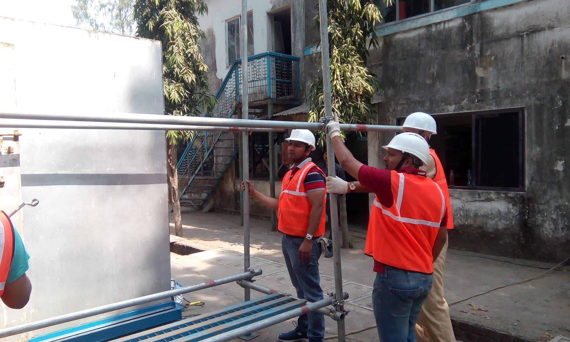 Trainee working on an erected scaffold structure during a practical scaffolding exercise