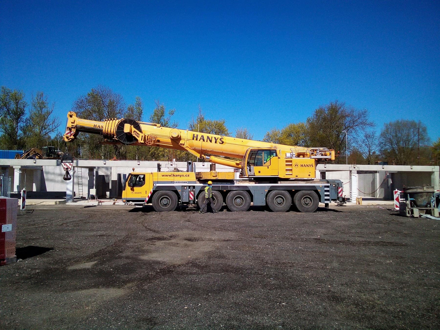 A mobile crane lifting a load on an industrial site
