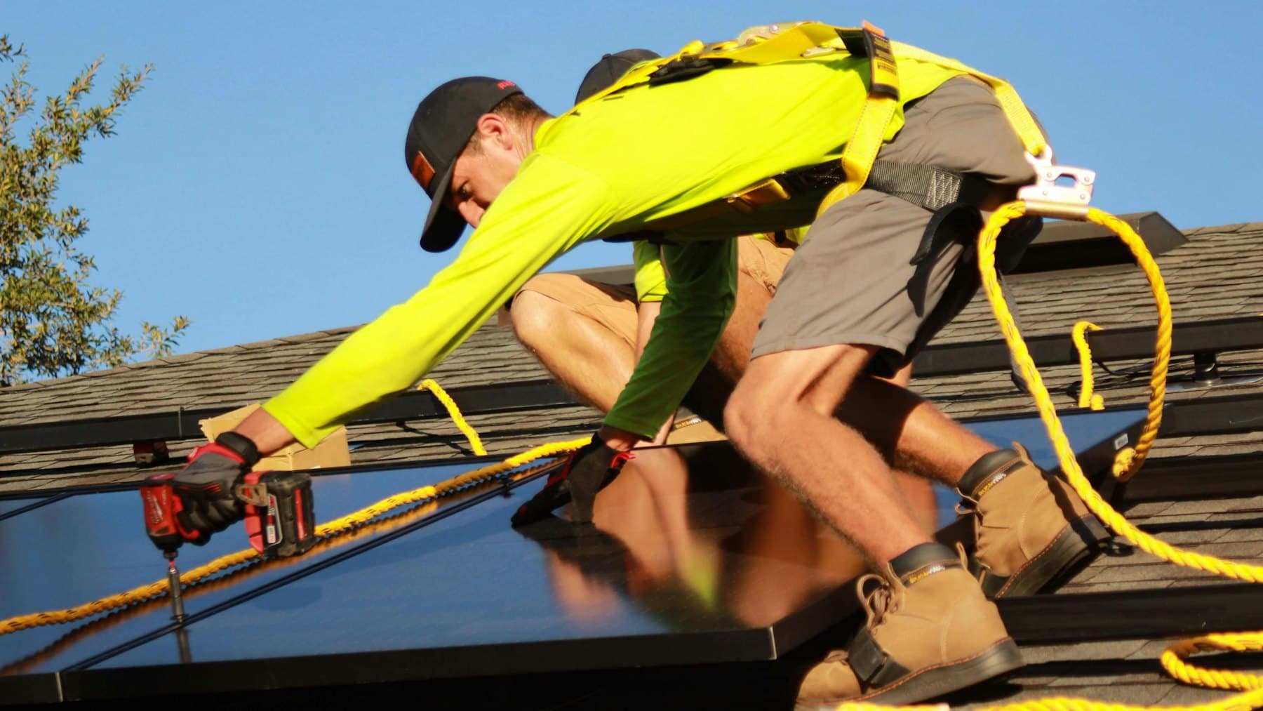 Technician working among rows of solar panels at a utility-scale PV installation