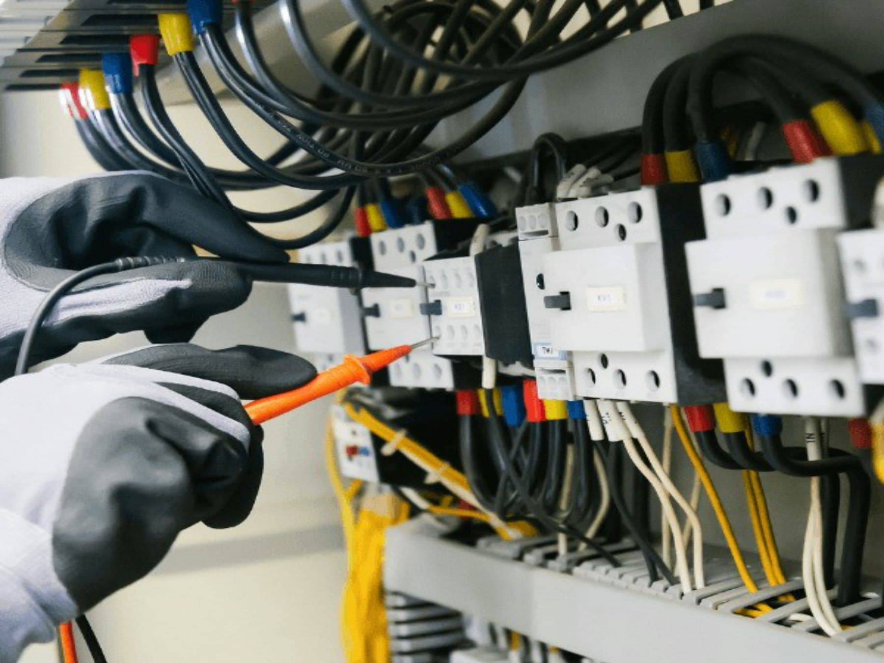 Technician applying a lock-off device to an electrical isolator